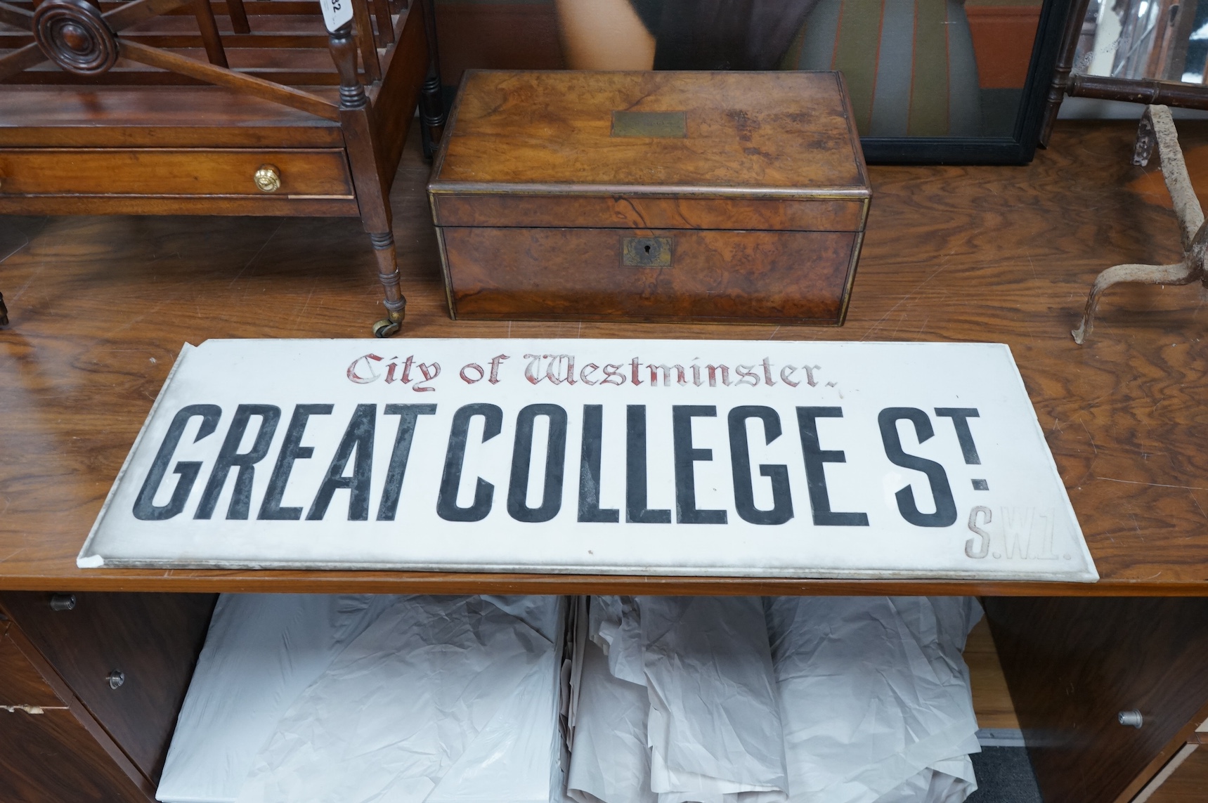 An early 20th century Vitrolite milk glass street sign, The City of Westminster, Great College Street, 30 x 91cm. Condition - chipped